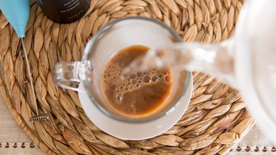 pouring mushroom coffee in a cup